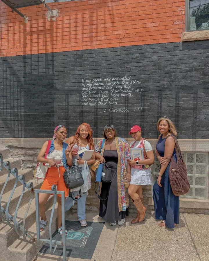 Christian women friends smiling together outside a coffee shop