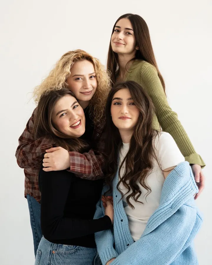 Four girlfriends posing together