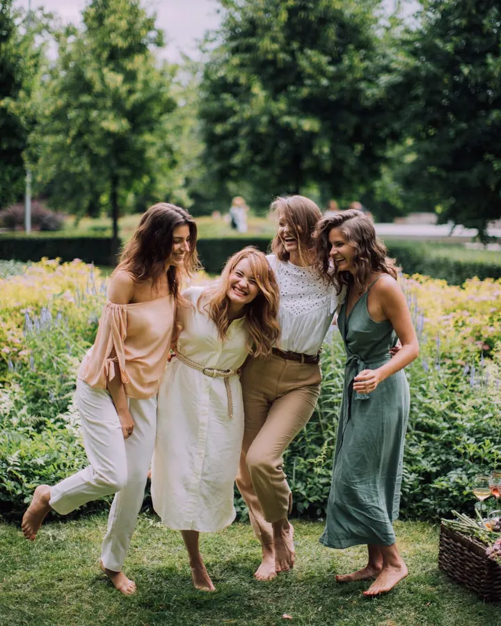 Four friends laughing in a garden